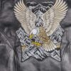 Back of men's black leather jacket with large white and gold eagle and mountain embroidery